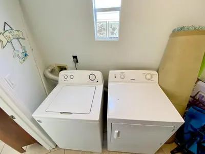 a small kitchen with a stove and a refrigerator at Venture Out 332 Lagoon Ln WITH 2 GOLF CARTS in Panama City Beach
