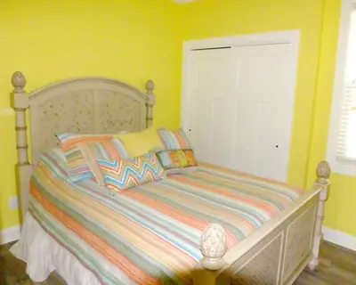 a bedroom with a bed with a white door at Venture Out 152 Gulf Loop With Golf Cart in Panama City Beach