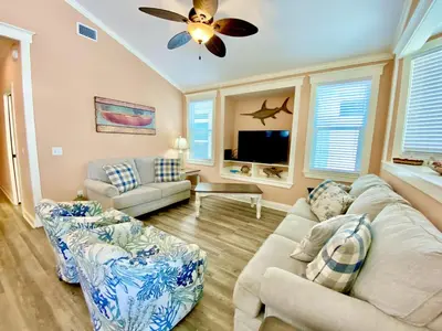 a living room with two couches and a ceiling fan at Venture Out 152 Gulf Loop With Golf Cart in Panama City Beach