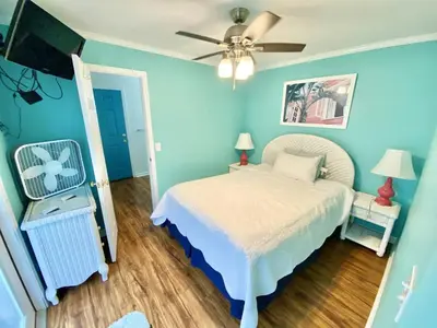 a bedroom with a bed and a ceiling fan at Venture Out 646 Octopus Dr Comes WITH GOLF CART in Panama City Beach