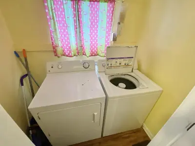 a washing machine in a small room with a window at Venture Out 646 Octopus Dr Comes WITH GOLF CART in Panama City Beach