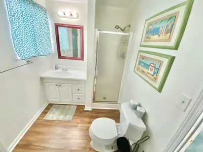 a bathroom with a toilet and a shower and a sink at Venture Out 646 Octopus Dr Comes WITH GOLF CART in Panama City Beach