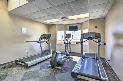 a gym with three tread machines in a room at PCB Condo with Resort Amenities and Ocean Views in Panama City Beach