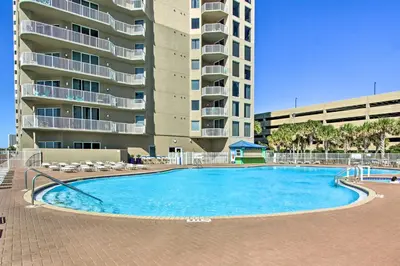 a large swimming pool in front of a building at PCB Condo with Resort Amenities and Ocean Views in Panama City Beach