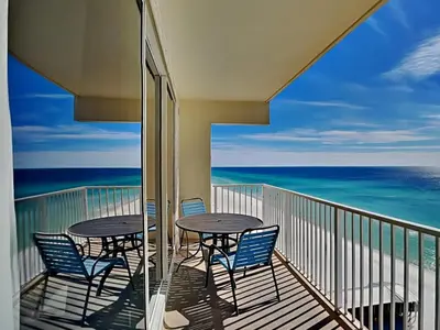 a balcony with two tables and chairs and the ocean at Shores of Panama #1330 in Panama City Beach