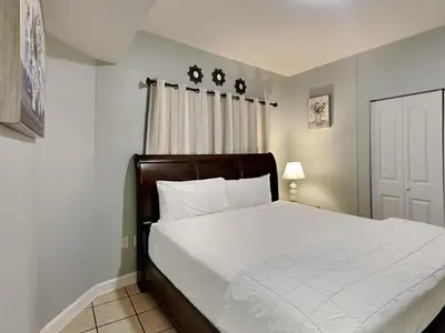 a bedroom with a large bed with white sheets at Shores of Panama #1330 in Panama City Beach