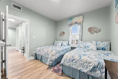 a bedroom with two beds and a window at Beach & Ocean Views! Steps to Beach & Dining, Sleeps 9! Dolce Vita Getaways PCB in Panama City Beach