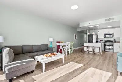 a living room with a couch and a table at Beach & Ocean Views! Steps to Beach & Dining, Sleeps 9! Dolce Vita Getaways PCB in Panama City Beach