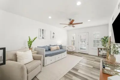 a living room with a couch and a ceiling fan at 4BD Resort Home Golf Cart Inc 11 Pools in Panama City Beach