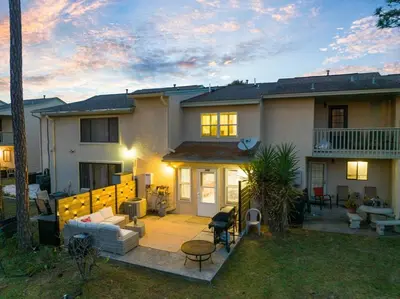 a house with a backyard with a patio at 4BD Resort Home Golf Cart Inc 11 Pools in Panama City Beach