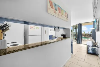 a kitchen with a counter with a counter top at 1st Floor Resort Condo! No Elevators! Free Beach Chair Service! by Dolce Vita Getaways PCB in Panama City Beach