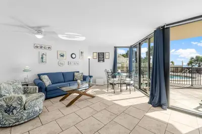 a living room with a couch and a table at 1st Floor Resort Condo! No Elevators! Free Beach Chair Service! by Dolce Vita Getaways PCB in Panama City Beach