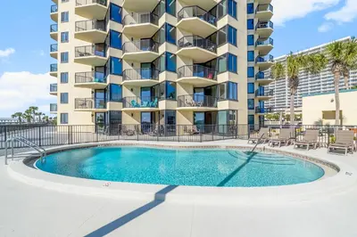 a swimming pool in front of a apartment building at 1st Floor Resort Condo! No Elevators! Free Beach Chair Service! by Dolce Vita Getaways PCB in Panama City Beach