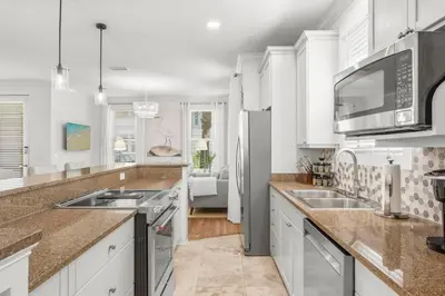 a kitchen with white cabinets and stainless steel appliances at 30A Beach House - Beach Ball by Panhandle Getaways in Inlet Beach