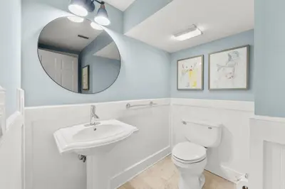 a bathroom with a white toilet and a mirror at 30A Beach House - Beach Ball by Panhandle Getaways in Inlet Beach