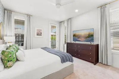 a white bedroom with a large bed and windows at 30A Beach House - Beach Ball by Panhandle Getaways in Inlet Beach