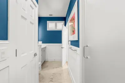 a bathroom with blue walls and a white door at 30A Beach House - Beach Ball by Panhandle Getaways in Inlet Beach