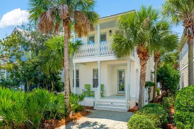 a white house with palm trees in front of it at 30A Beach House - Beach Ball by Panhandle Getaways in Inlet Beach