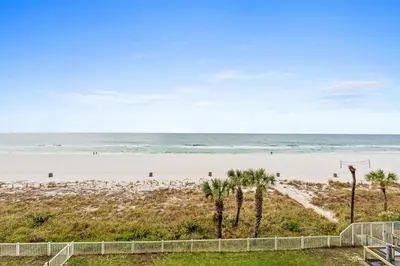 a beach with palm trees and the ocean at Long Beach Resort 302 Tower 2 By Book That Condo in Panama City Beach