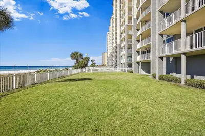 a large lawn in front of a building with the beach at Long Beach Resort 302 Tower 2 By Book That Condo in Panama City Beach