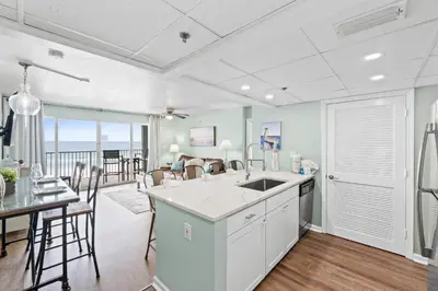 a kitchen and dining room with a view of the ocean at Long Beach Resort 302 Tower 2 By Book That Condo in Panama City Beach