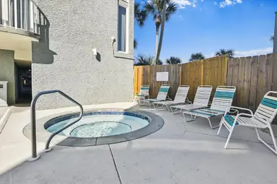 a group of chairs and a hot tub on a patio at Long Beach Resort 302 Tower 2 By Book That Condo in Panama City Beach