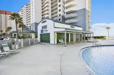 a building with a swimming pool next to a building at Long Beach Resort 302 Tower 2 By Book That Condo in Panama City Beach