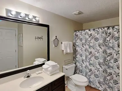a bathroom with a sink and a toilet and a shower at Twin Palms #1501A in Panama City Beach