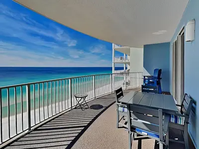 a balcony with a table and chairs and the ocean at Twin Palms #1501A in Panama City Beach