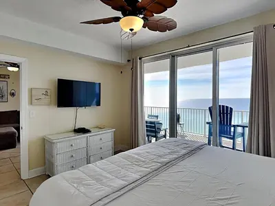 a bedroom with a bed and a flat screen tv at Twin Palms #1501A in Panama City Beach