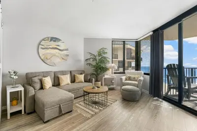 a living room with a couch and a table at Fun N The Sun at Sunbird #1102W by InJoy Vacations in Panama City Beach