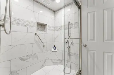 a bathroom with a shower with a glass door at Fun N The Sun at Sunbird #1102W by InJoy Vacations in Panama City Beach