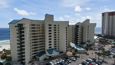 a large building with cars parked in a parking lot at Fun N The Sun at Sunbird #1102W by InJoy Vacations in Panama City Beach