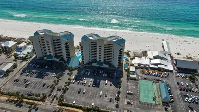 two tall buildings on the beach next to the ocean at Fun N The Sun at Sunbird #1102W by InJoy Vacations in Panama City Beach