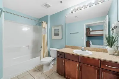 a bathroom with a sink and a toilet and a shower at Laketown Wharf #1014 in Panama City Beach