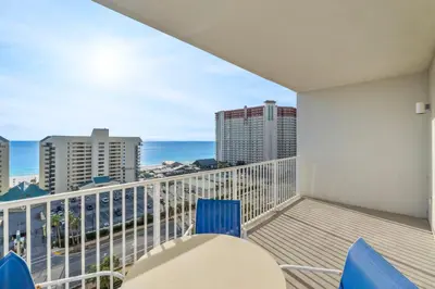 a balcony with a table and chairs and the ocean at Laketown Wharf #1014 in Panama City Beach