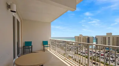 a balcony with a table and chairs and a view of the ocean at Laketown Wharf #1025 in Panama City Beach