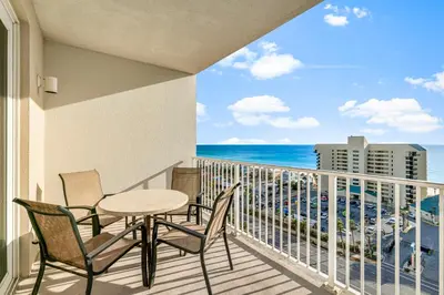 a balcony with a table and chairs and the ocean at Laketown Wharf #1115 in Panama City Beach