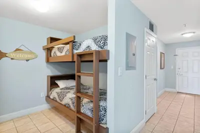 a room with a bunk bed and a hallway at Laketown Wharf #1115 in Panama City Beach