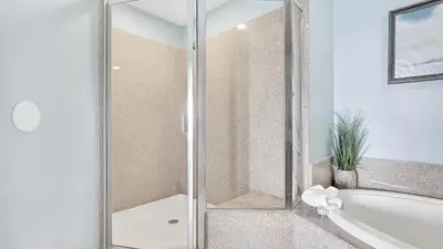a bathroom with a shower and a bath tub at Laketown Wharf #0109 in Panama City Beach