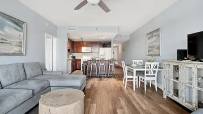 a living room and kitchen with a couch and a table at Laketown Wharf #0109 in Panama City Beach