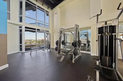 a gym with two tread machines in a room at Laketown Wharf #1206 in Panama City Beach