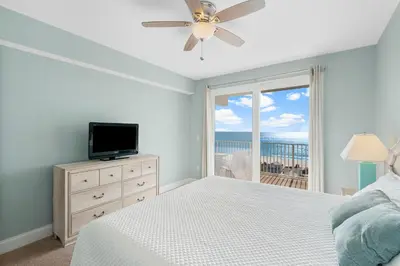 a bedroom with a bed and a tv and a window at Laketown Wharf #1206 in Panama City Beach