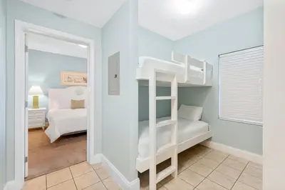 a bedroom with two bunk beds and a mirror at Laketown Wharf #1206 in Panama City Beach