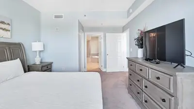 a bedroom with a large bed and a flat screen tv at Laketown Wharf #0127 in Panama City Beach