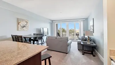 a living room with a couch and a dining room at Laketown Wharf #0127 in Panama City Beach