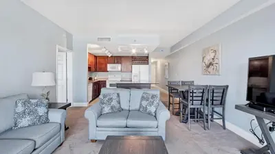 a living room with a couch and a dining room at Laketown Wharf #0127 in Panama City Beach
