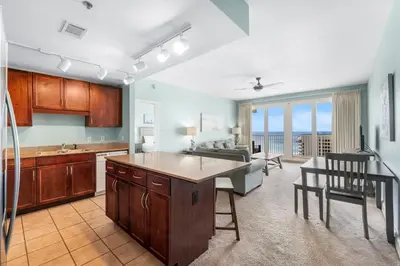 a kitchen and living room with a view of the ocean at Laketown Wharf #1209 in Panama City Beach
