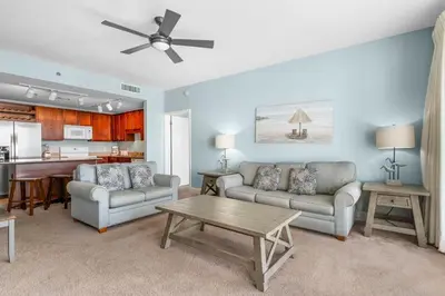 a living room with two couches and a table at Laketown Wharf #1209 in Panama City Beach