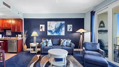 a living room with a couch and a table at Laketown Wharf #1537 in Panama City Beach